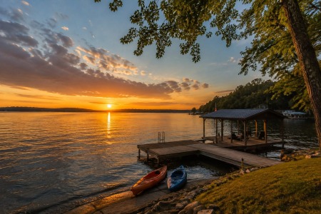 Sunset over Wilson Lake in Muscle Shoals, Alabama with a private dock, kayaks, and peaceful waterfront vacation rental.